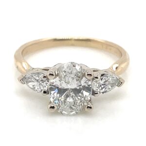 1.01 Carat Oval Center Stone Diamond Ring With 0.32ctw Pear Shape Accents in 18KYG